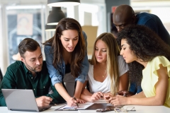 Multi-ethnic group of young men and women studying indoors.
